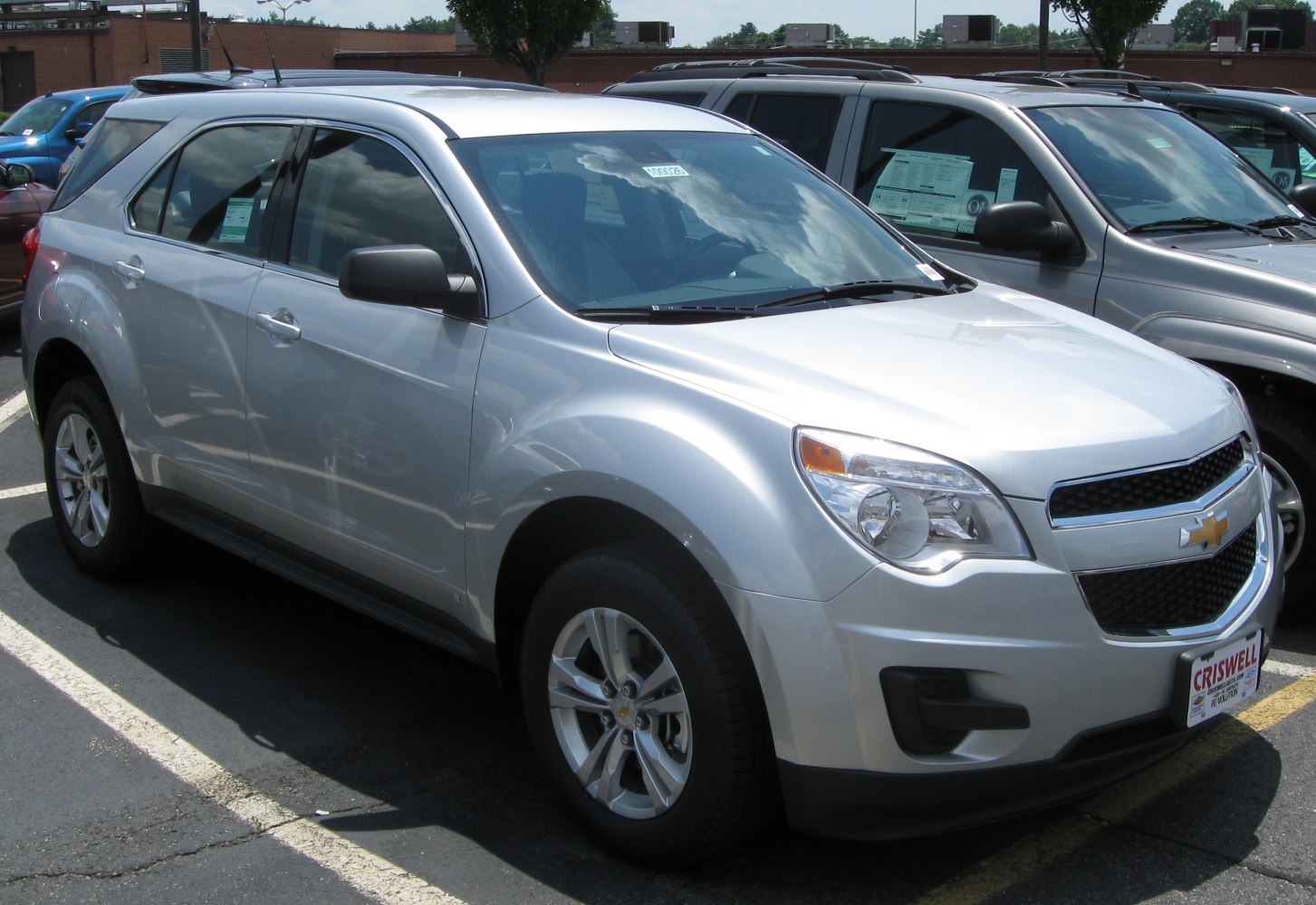 Silver mid-size SUV with front grille and headlight details