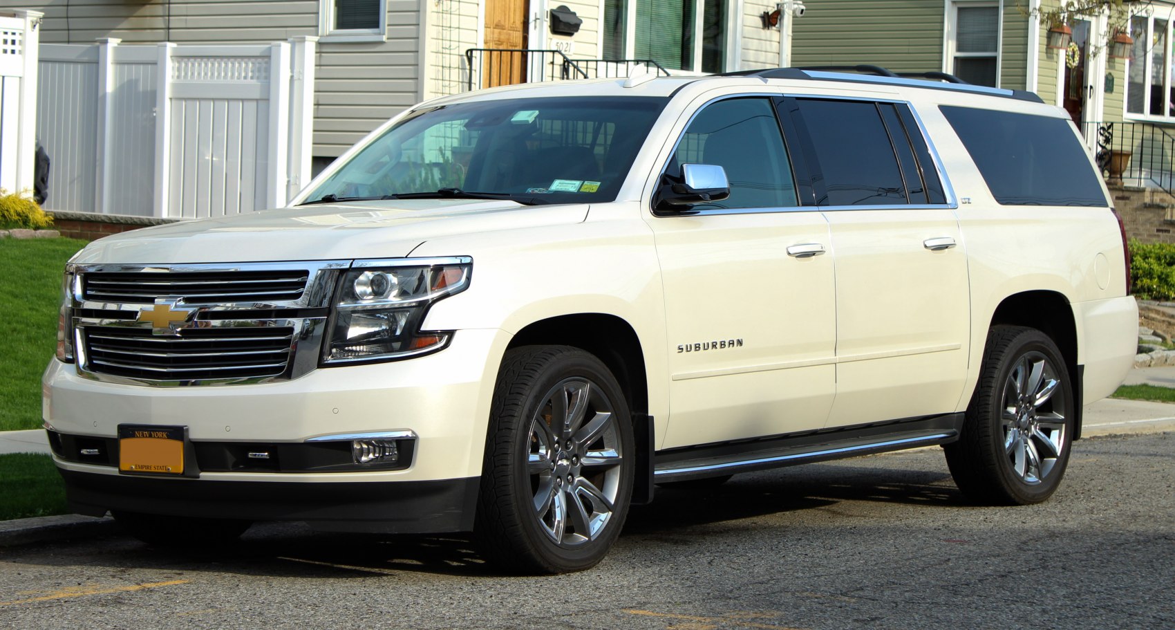 Front side view of a large SUV with chrome grille and alloy wheels