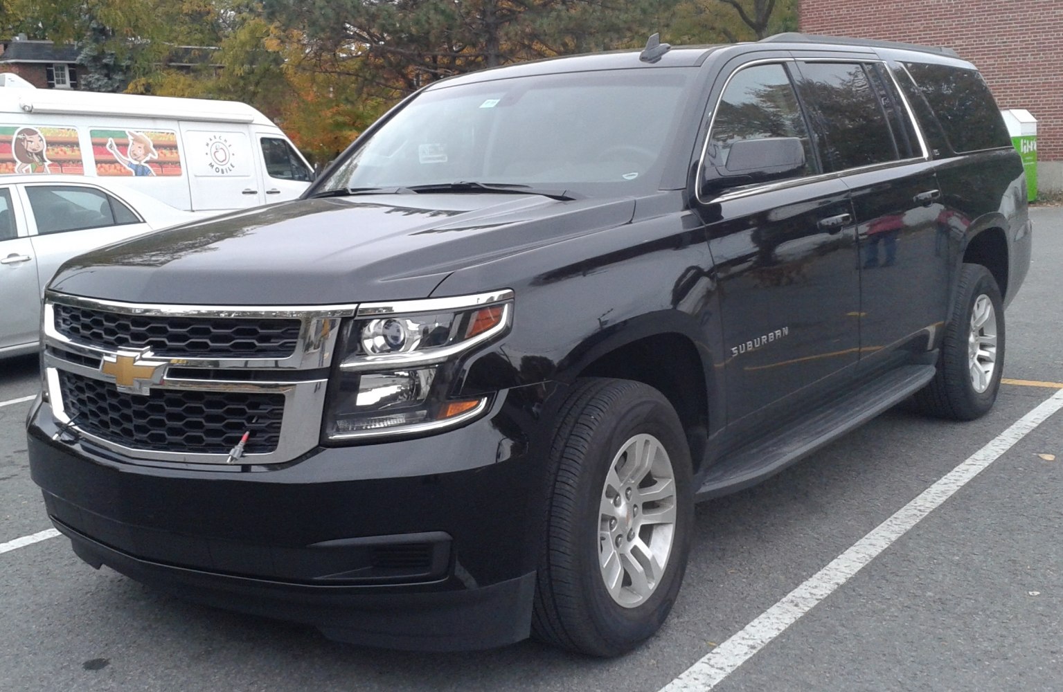 SUV front grille and headlights with side steps, large black vehicle
