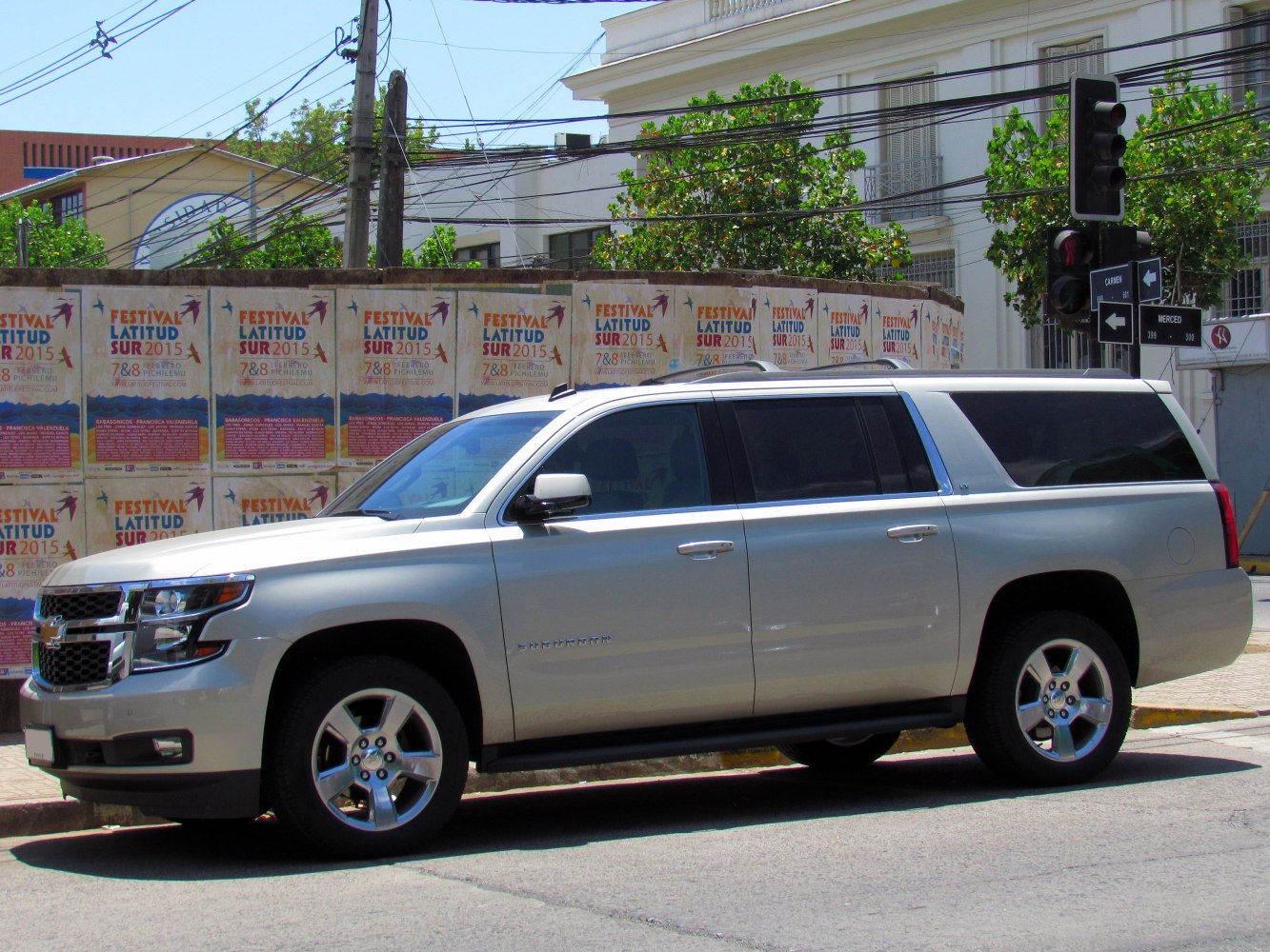 Silver full-size SUV with chrome accents and five-spoke alloy wheels