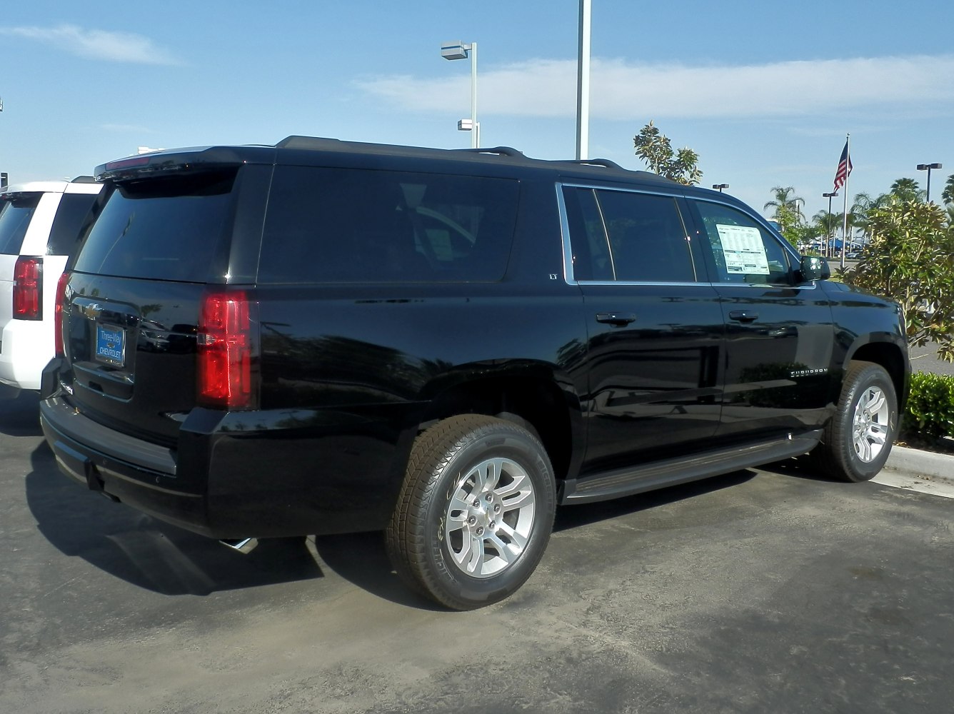 Large black SUV with rear side and wheel visible