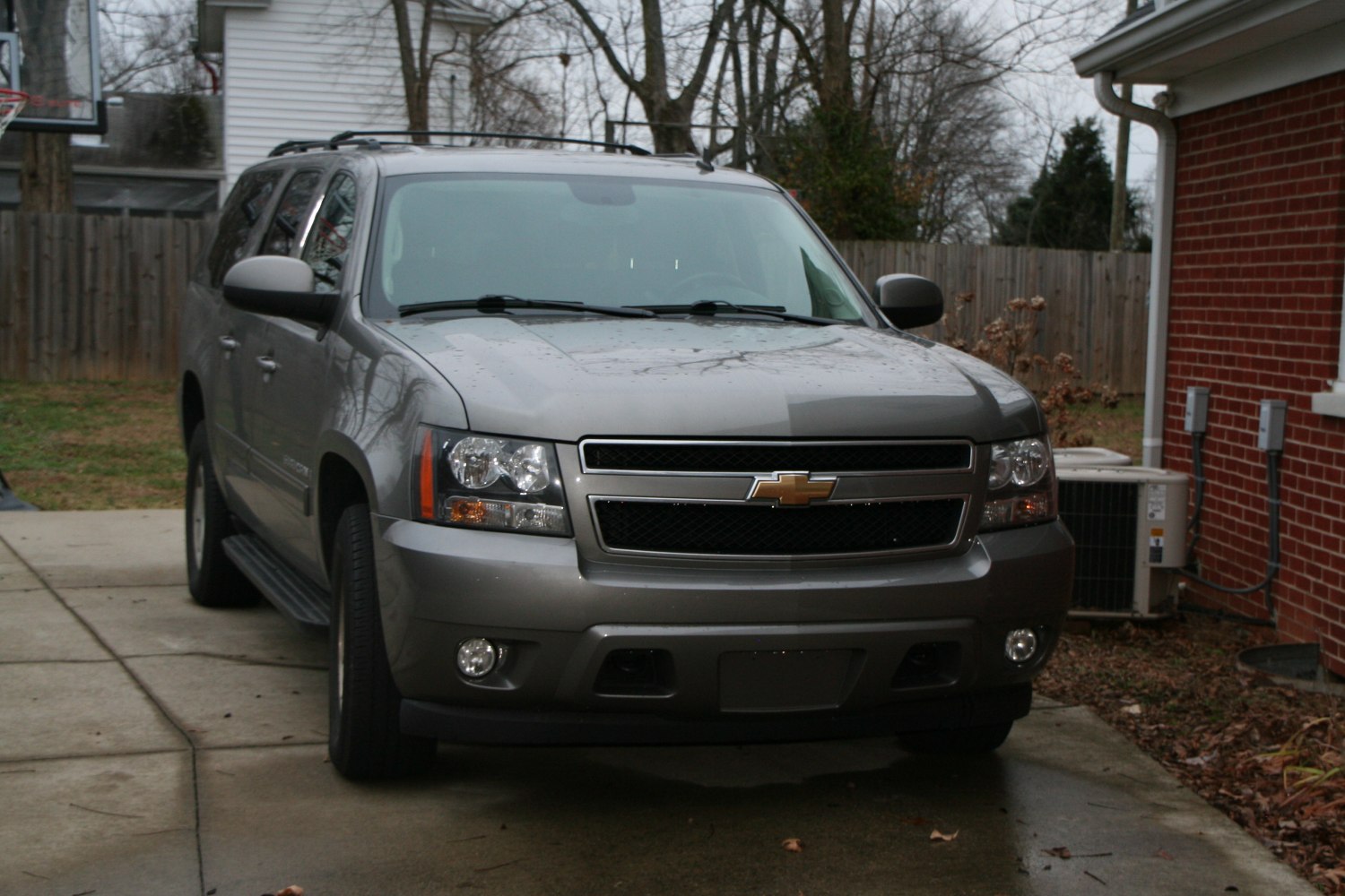 Front view of large SUV featuring grille, headlights, and roof rack.