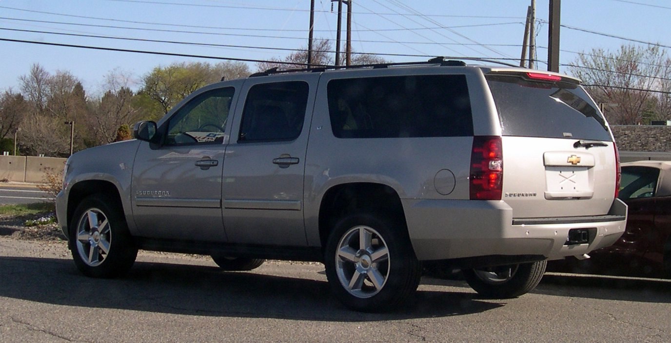 Rear-side view of a large SUV with tinted windows and alloy wheels
