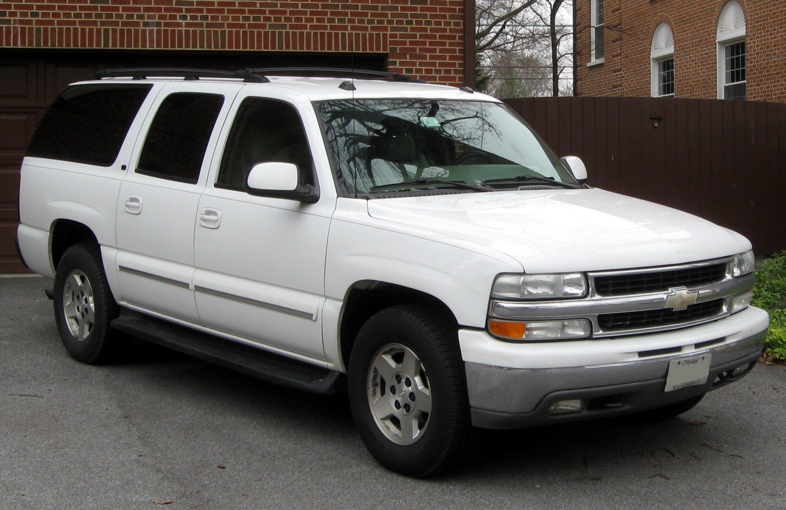 White large full size SUV with tinted windows and chrome grille.