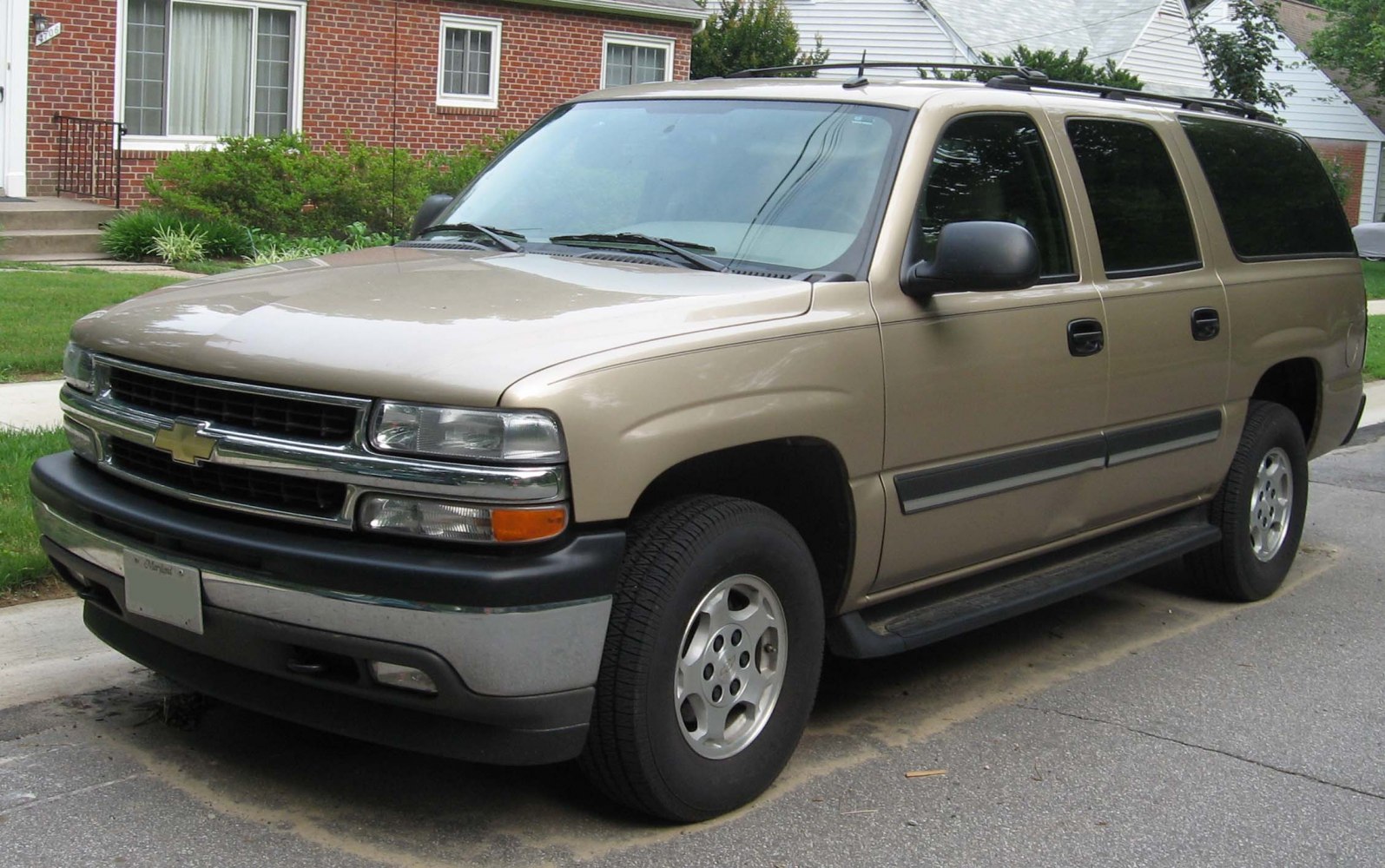 Beige large SUV front side with classic boxy styling and chrome grille