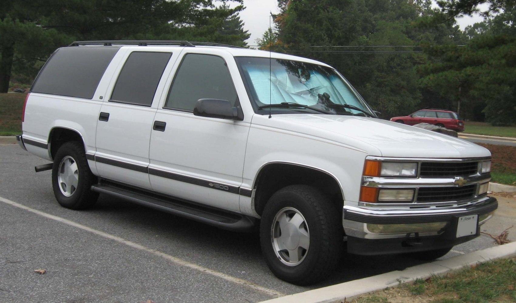 White full-size SUV with side view and rugged exterior