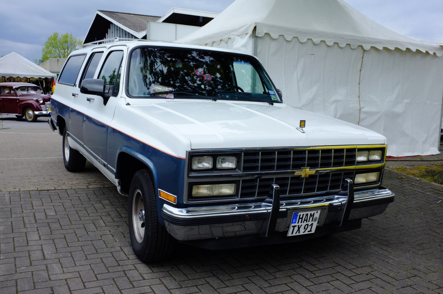 Vintage full-size SUV front with dual rectangular headlights and chrome bumper