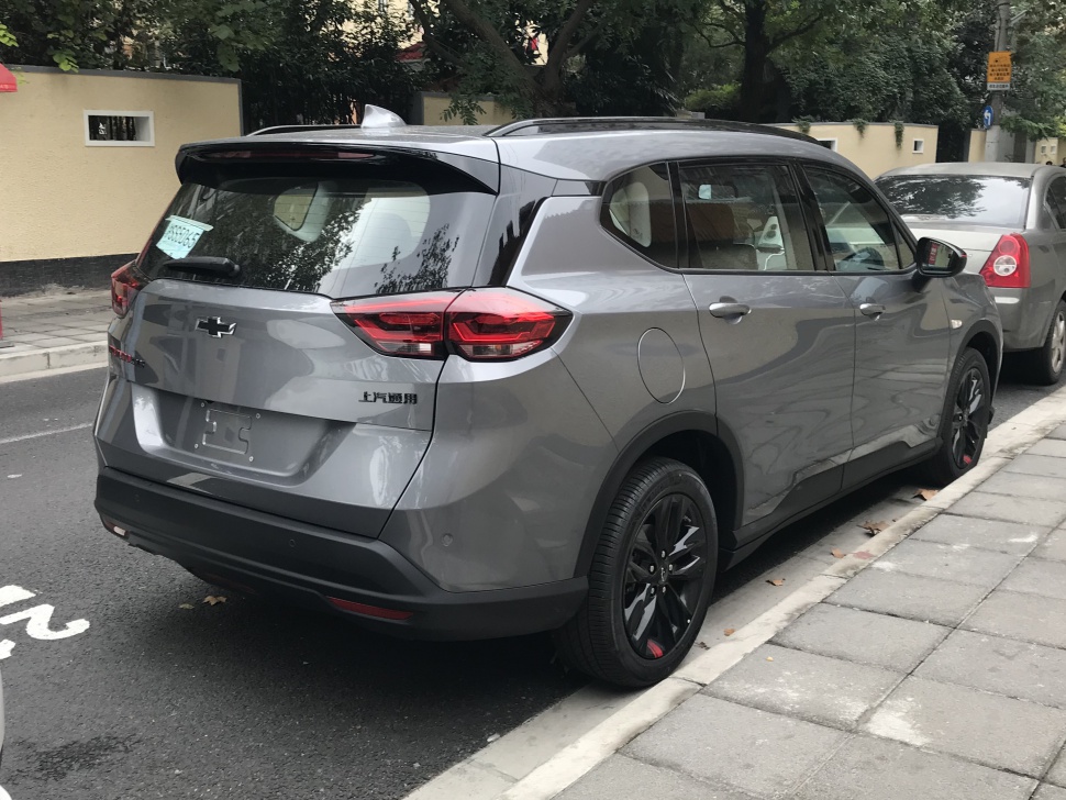 Rear and side exterior view of a compact SUV with black alloy wheels