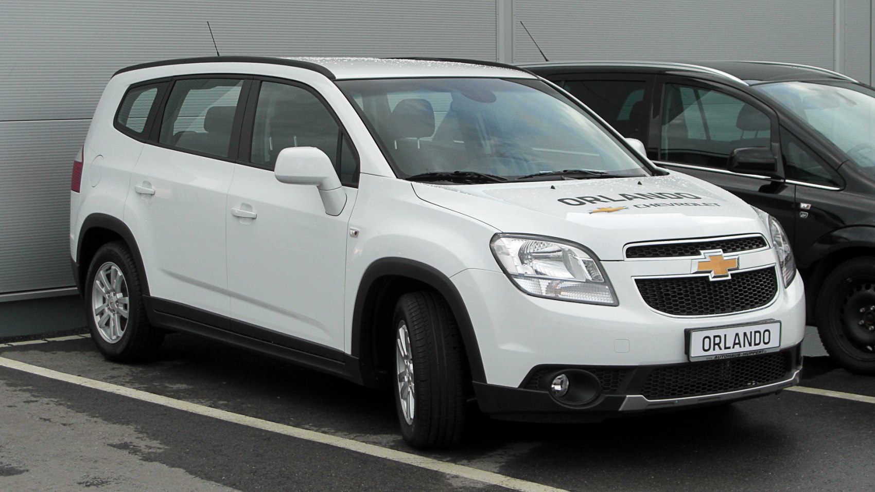 Front-side view of white multi-purpose vehicle with angular headlights and mesh grille