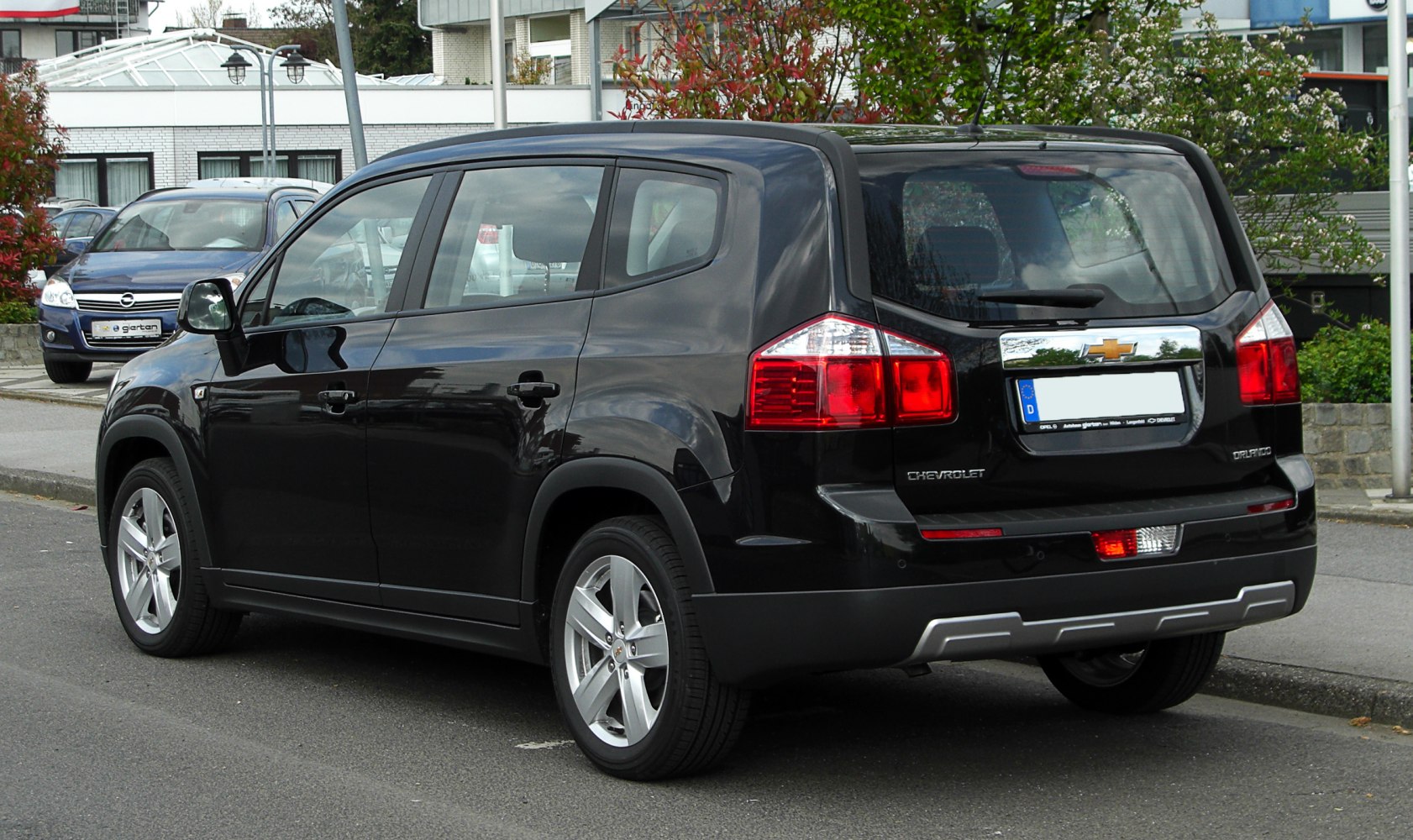 Rear view of black SUV with prominent tail lights and large rear window