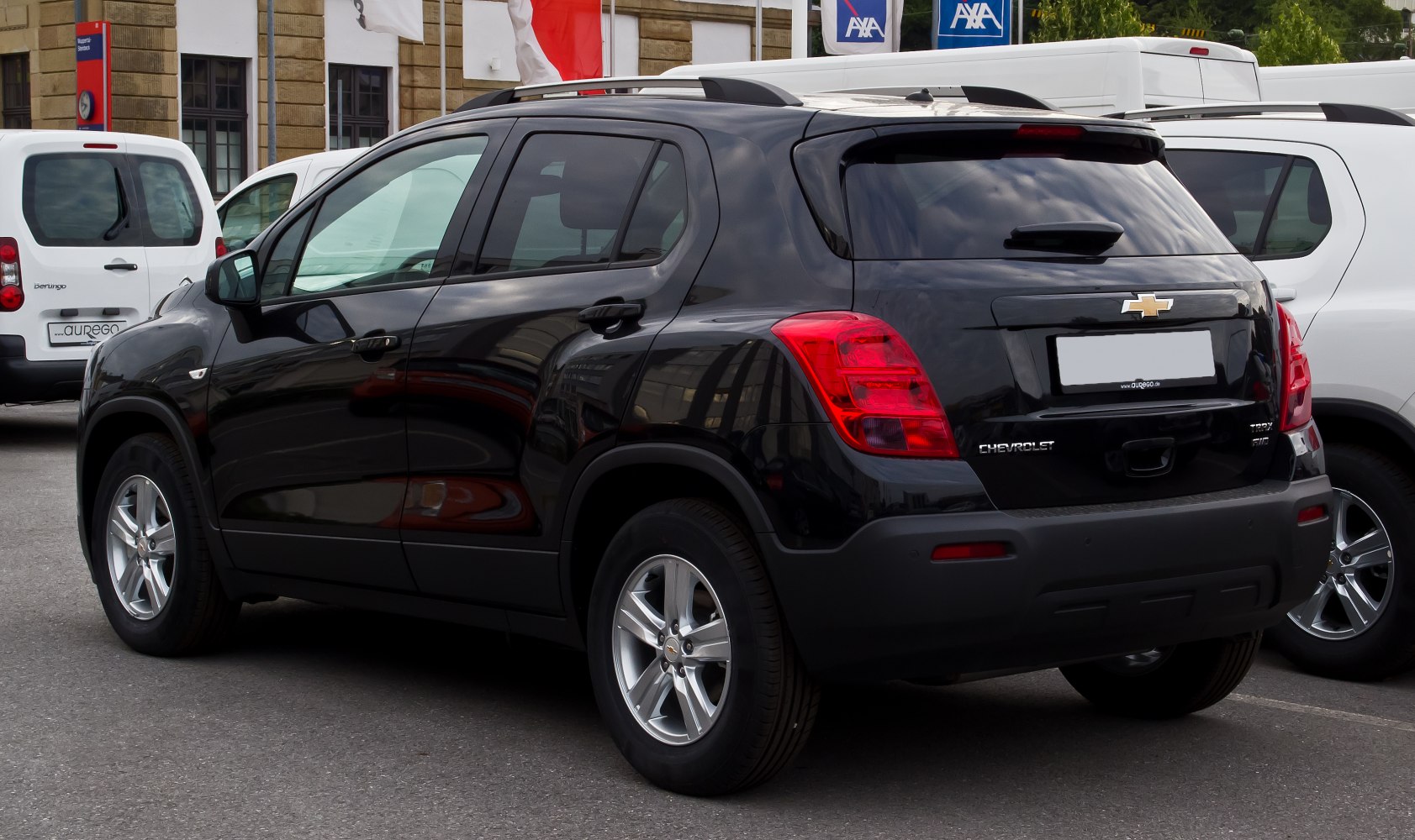 Rear side view of black subcompact SUV with alloy wheels and roof rails