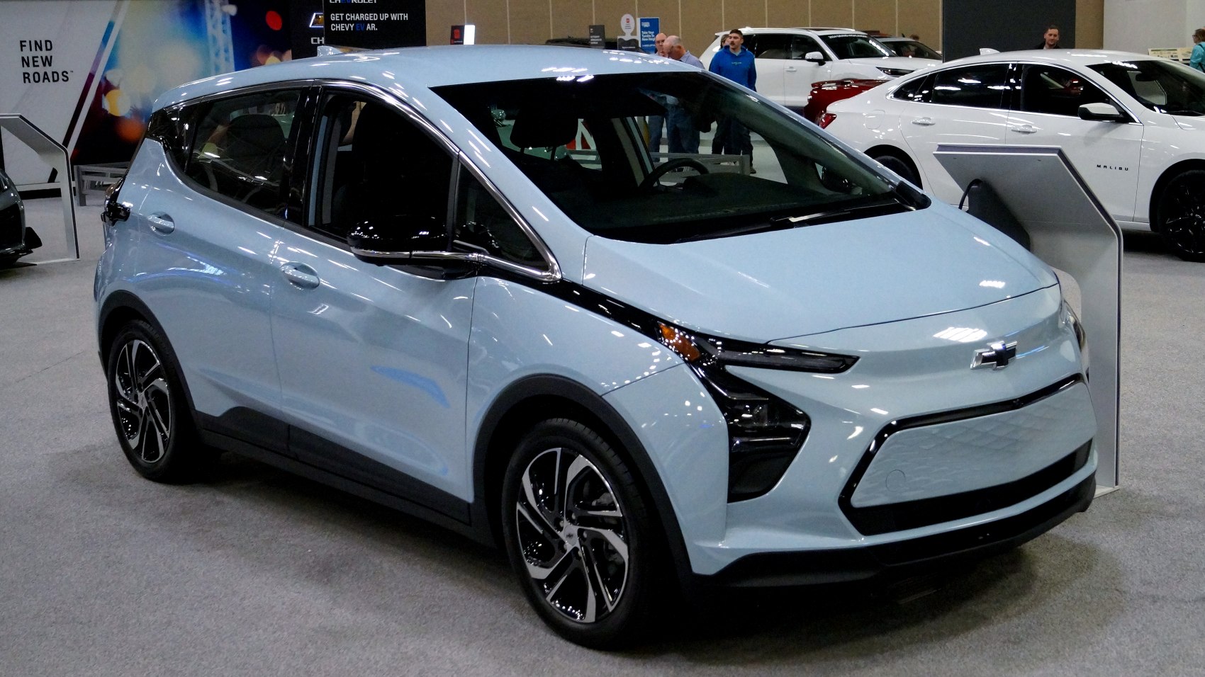 Front three-quarter view of an electric hatchback with modern headlights and aerodynamic shape
