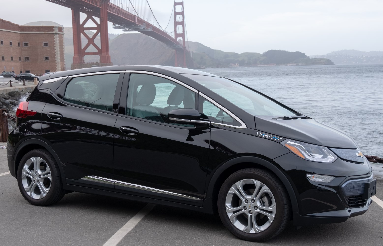 Side view of black electric hatchback with alloy wheels.