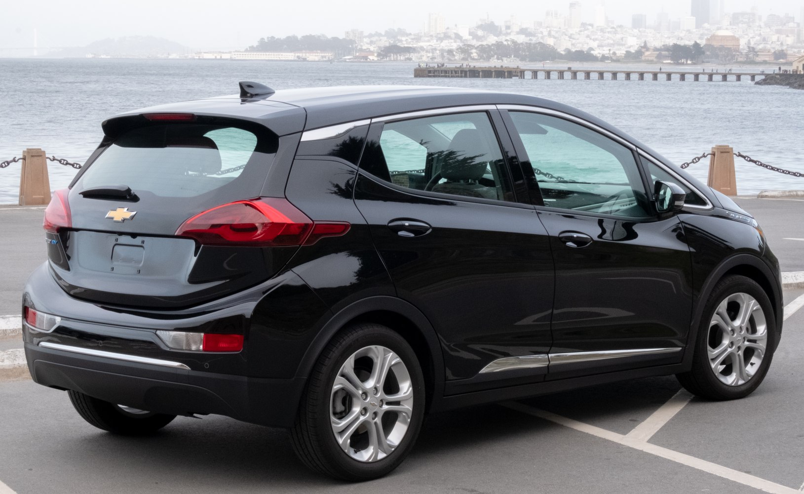 Rear side view of electric hatchback with distinctive taillights and chrome details