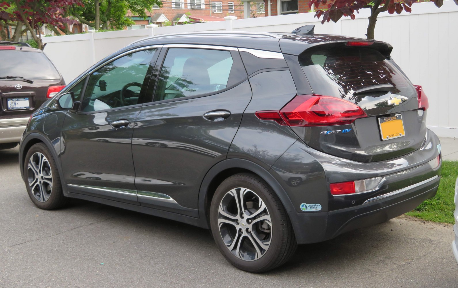 Rear side view of modern electric hatchback with distinctive taillights and spoiler