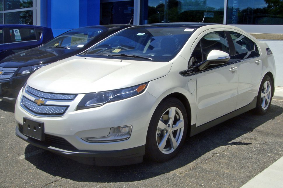 Front-side view of a hybrid sedan with aerodynamic design and alloy wheels