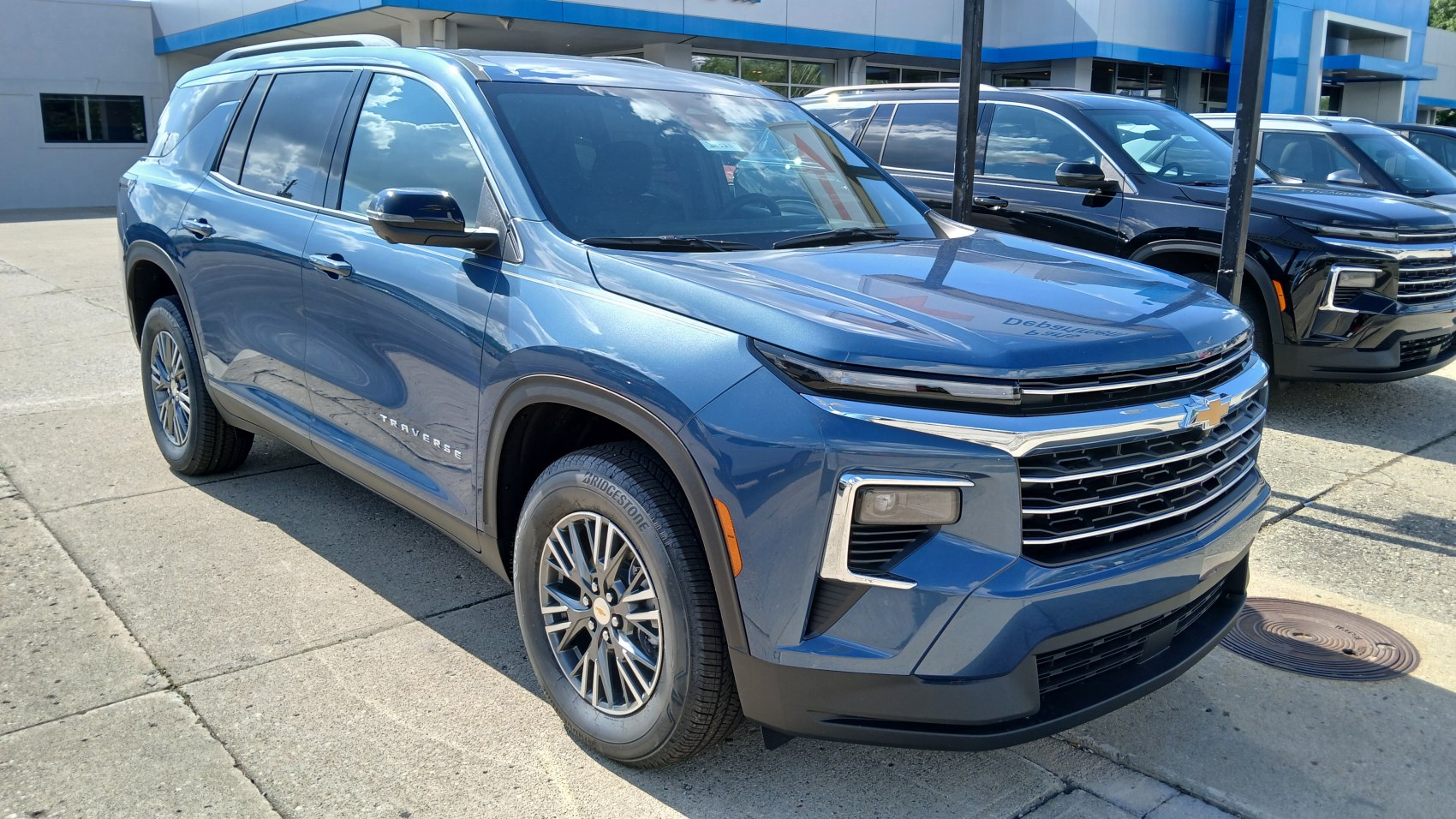 Sleek front-side view with LED headlights and bold grille