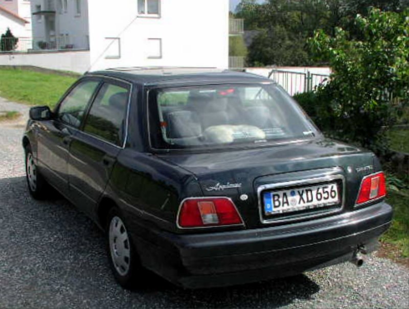 Rear view of classic compact sedan with distinct tail lights