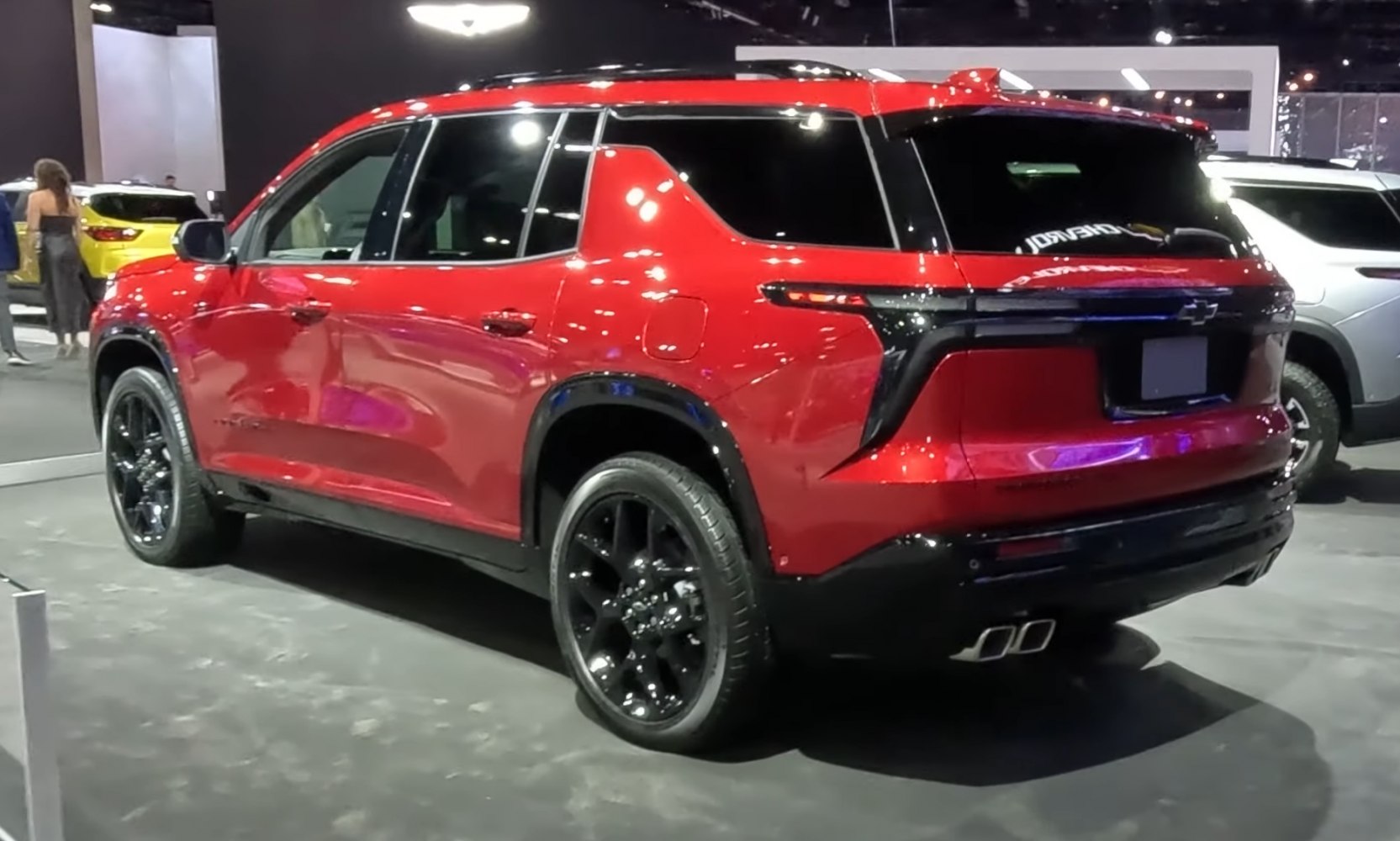 Rear side view of red SUV with black alloy wheels and tinted windows