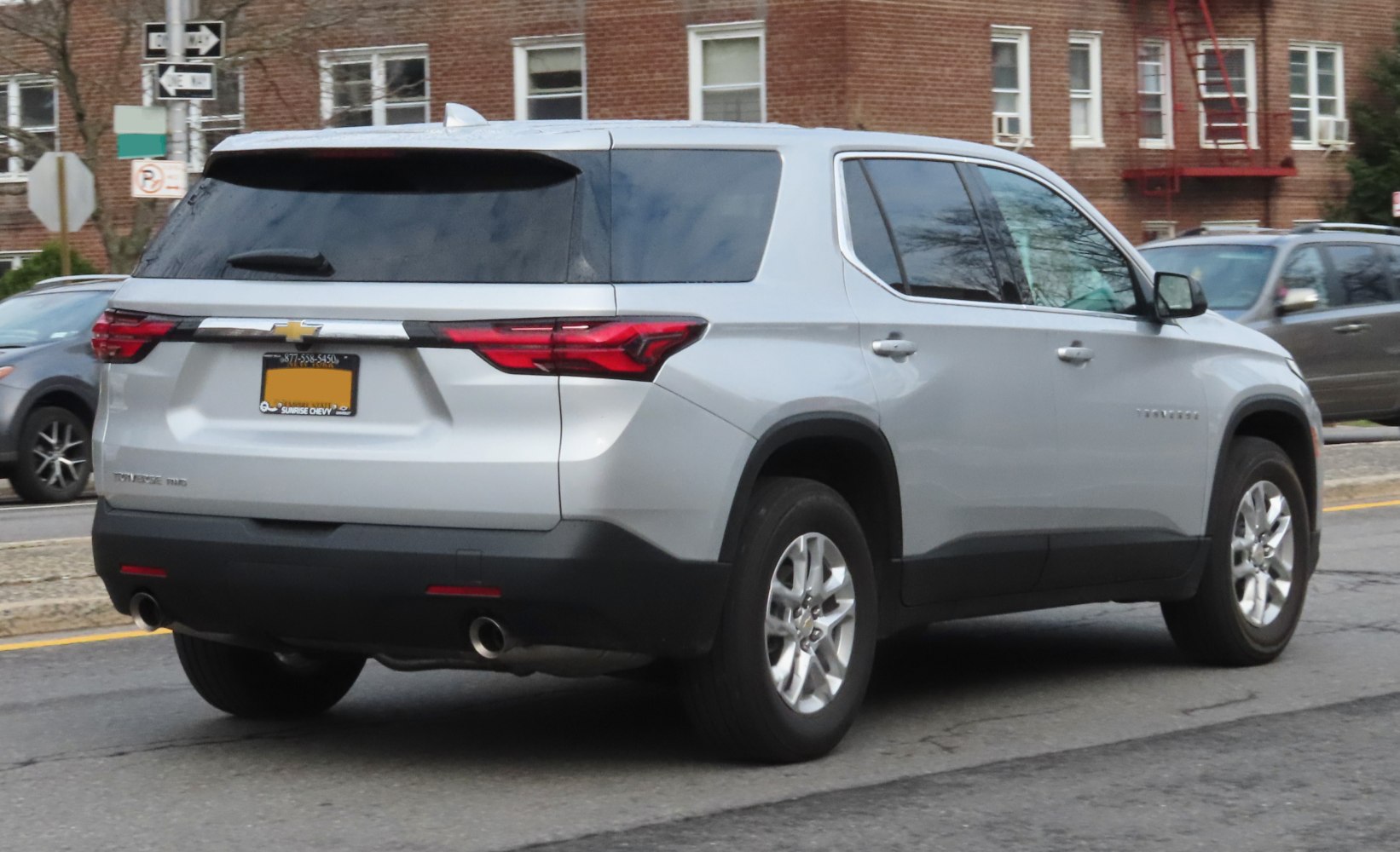 Rear view of silver SUV with dual exhaust and tinted windows