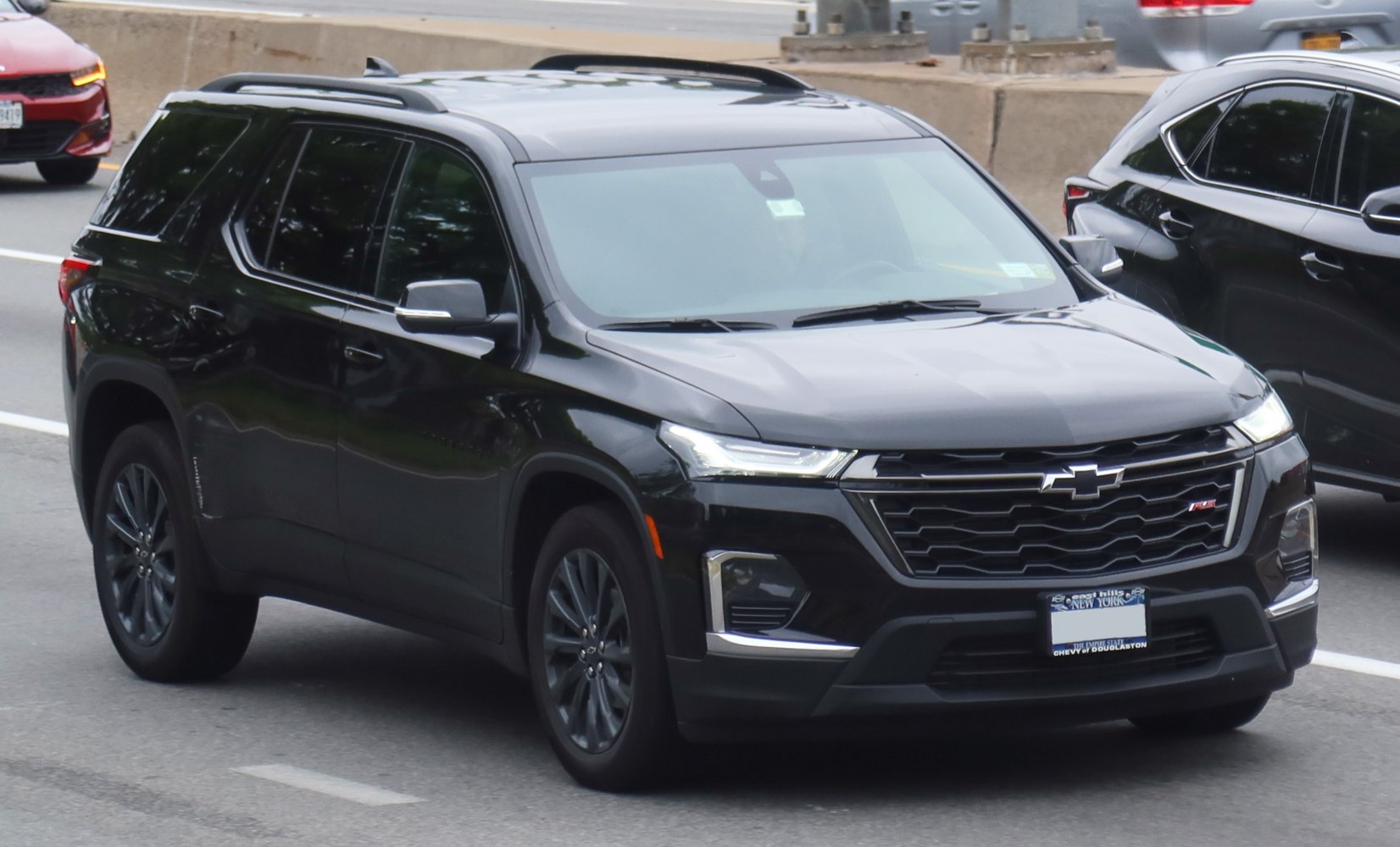 Black SUV with LED headlights, roof rails, and modern front grille