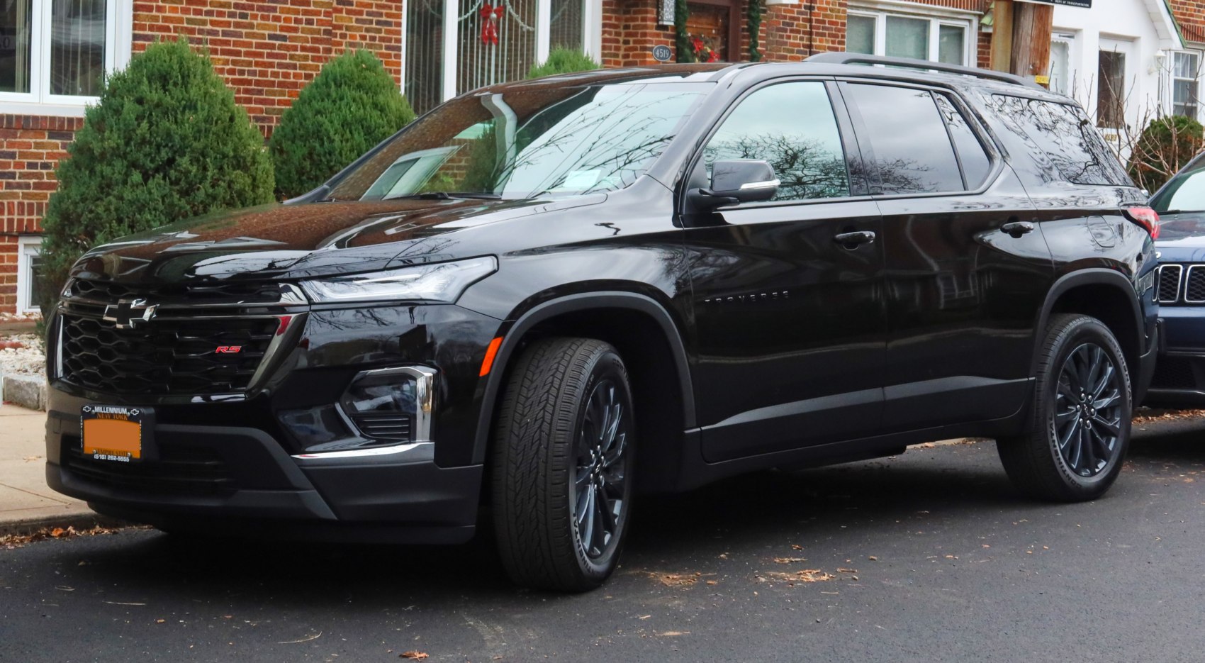 Black SUV with sleek LED headlights and black alloy wheels parked curbside