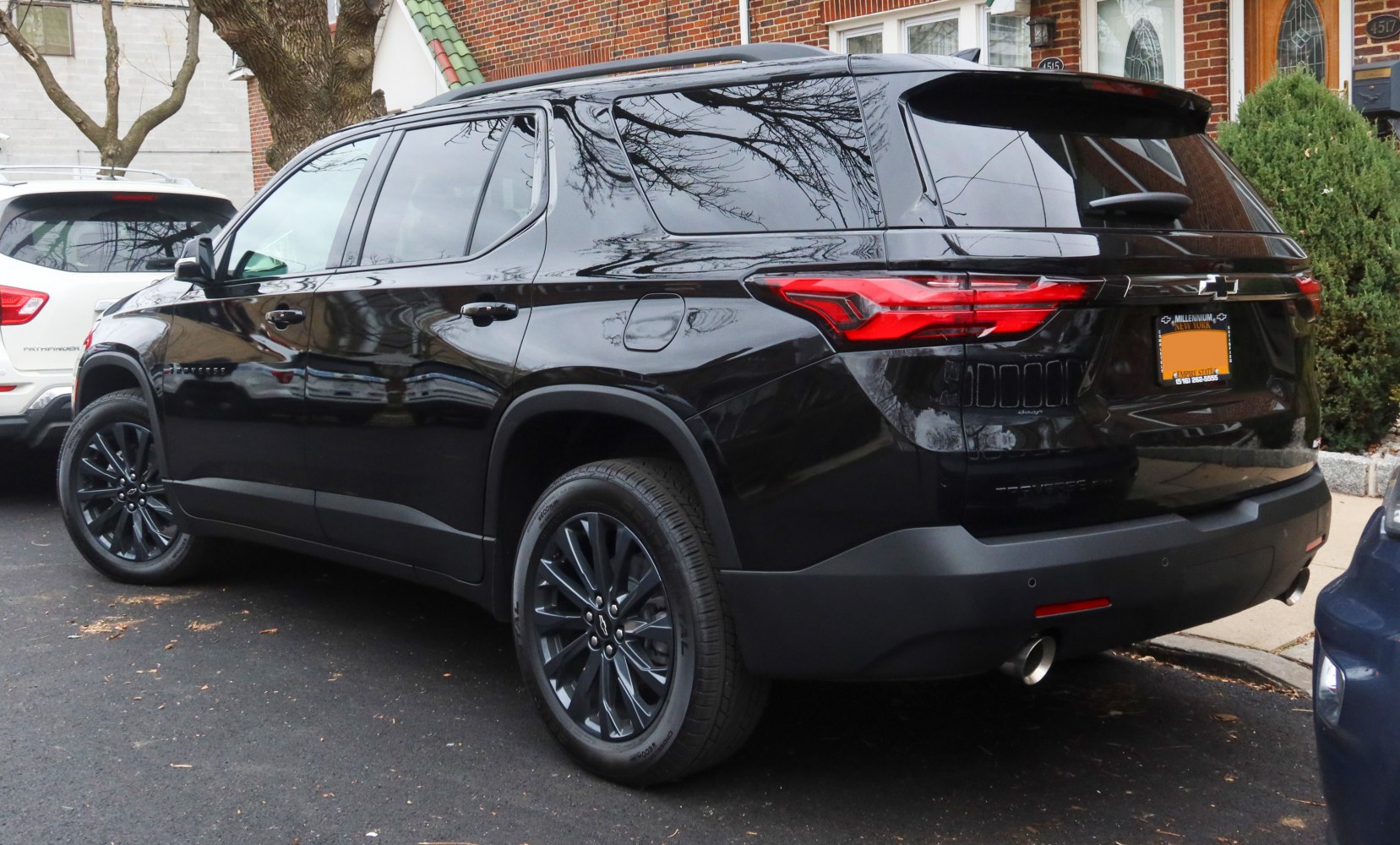 Rear side view of a black SUV with distinctive taillights and black wheels