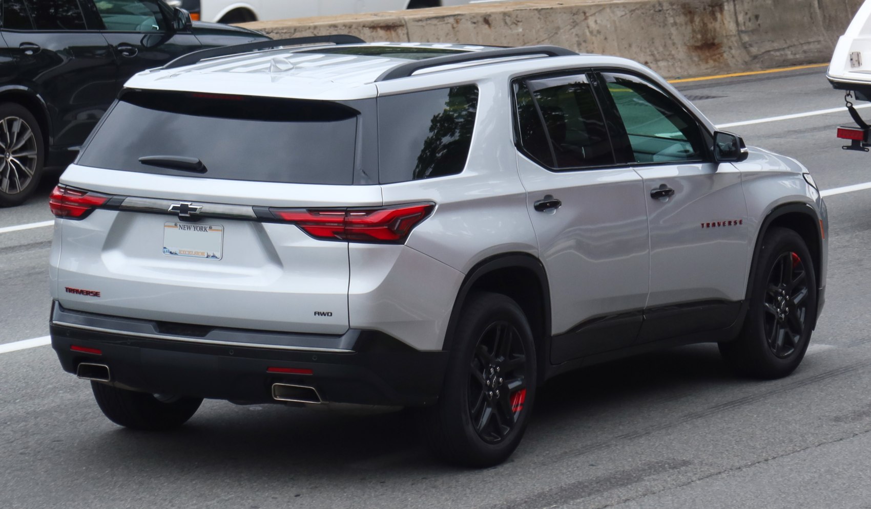 Rear view of silver SUV with dual exhaust and black wheels