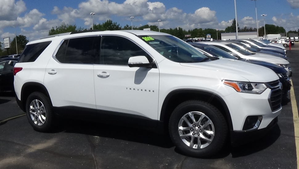 White full-size SUV side profile with alloy wheels and black trim