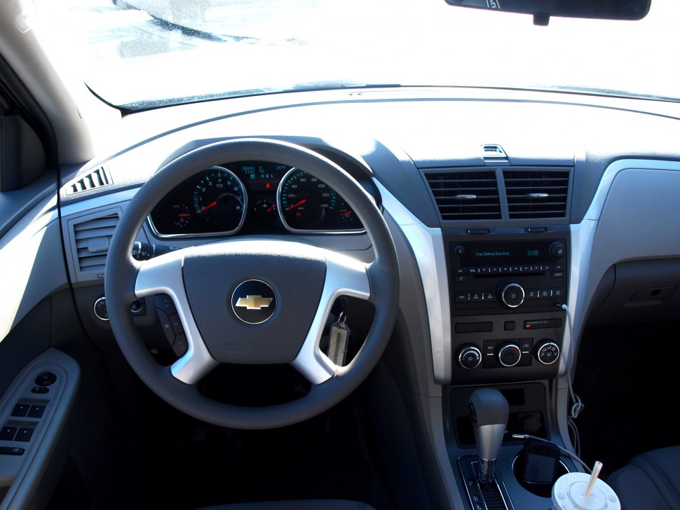 Steering wheel and dashboard with control panel and gear shift