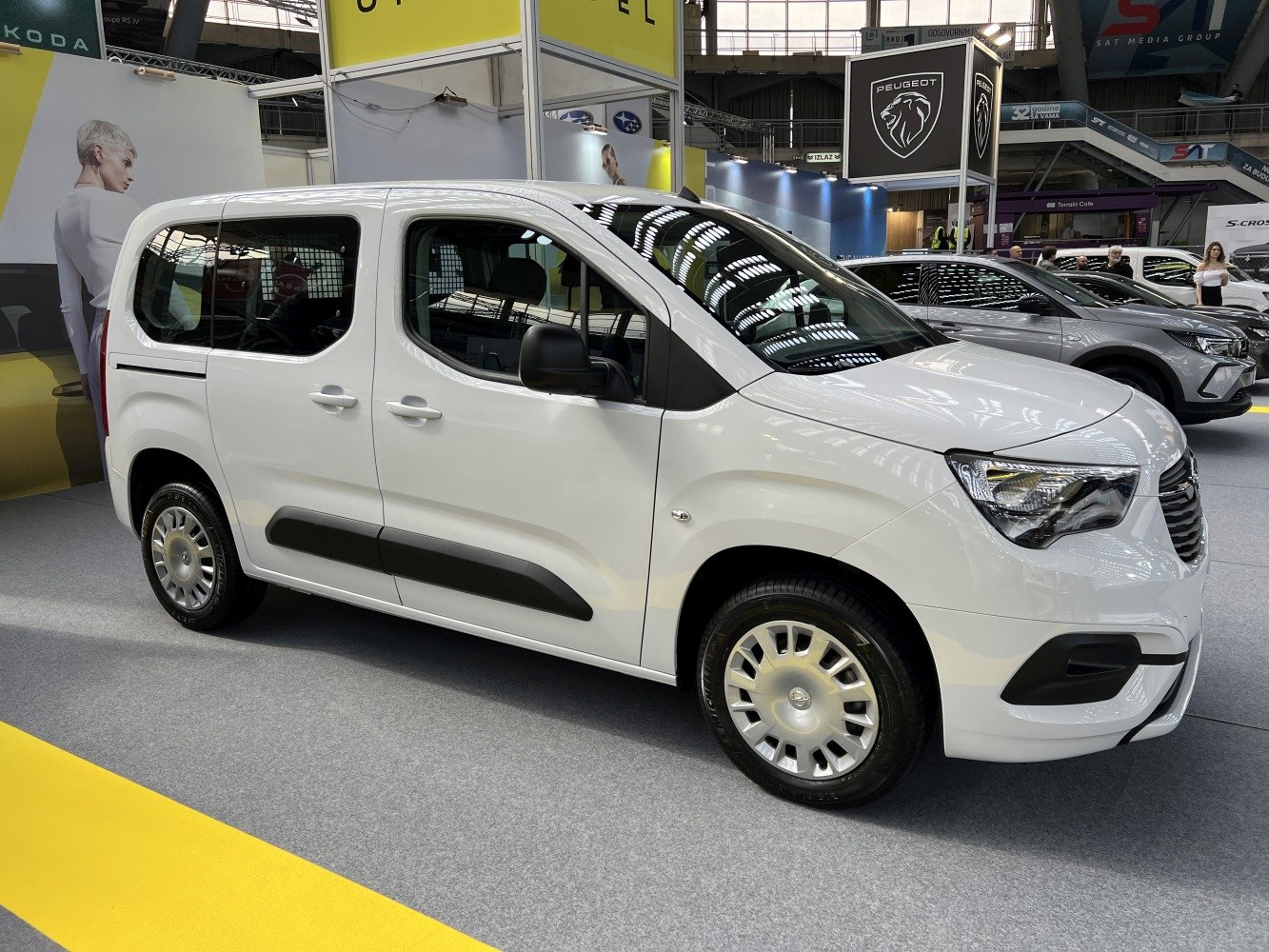 White compact MPV with sliding rear door and large windows