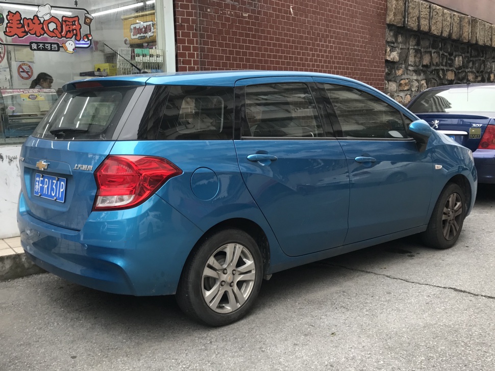 Blue station wagon rear and side view with unique tail lights and fuel cap