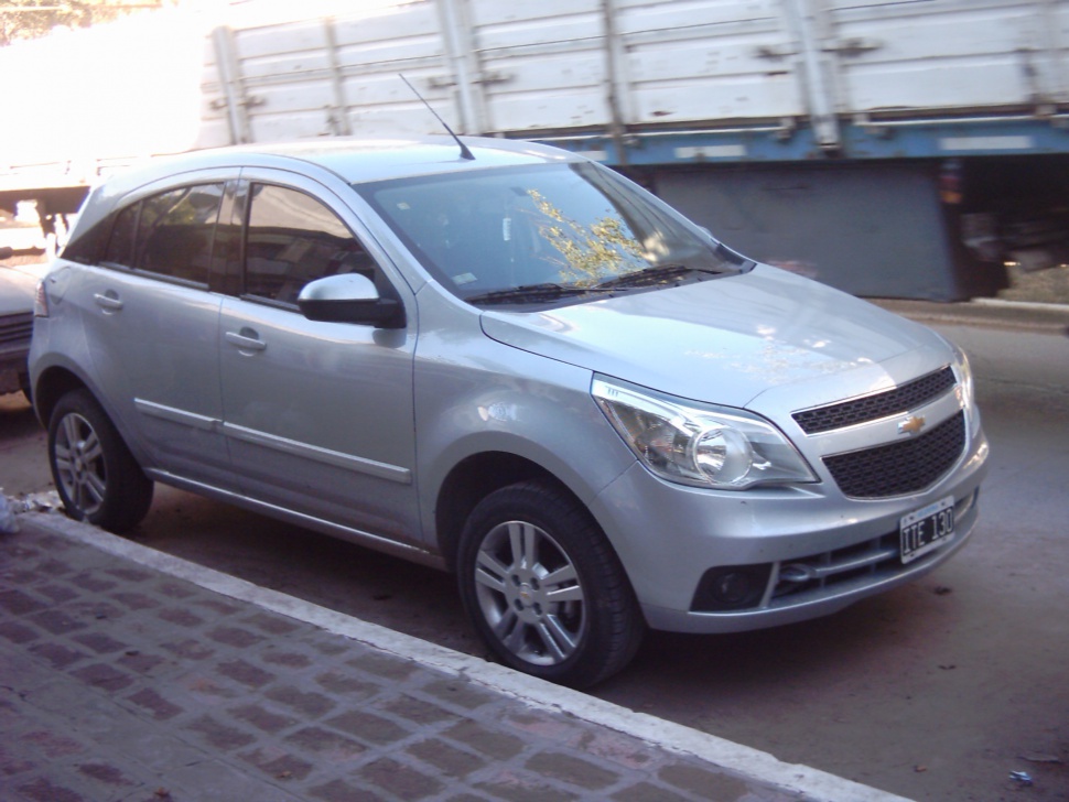 Silver hatchback front side with headlight and grille