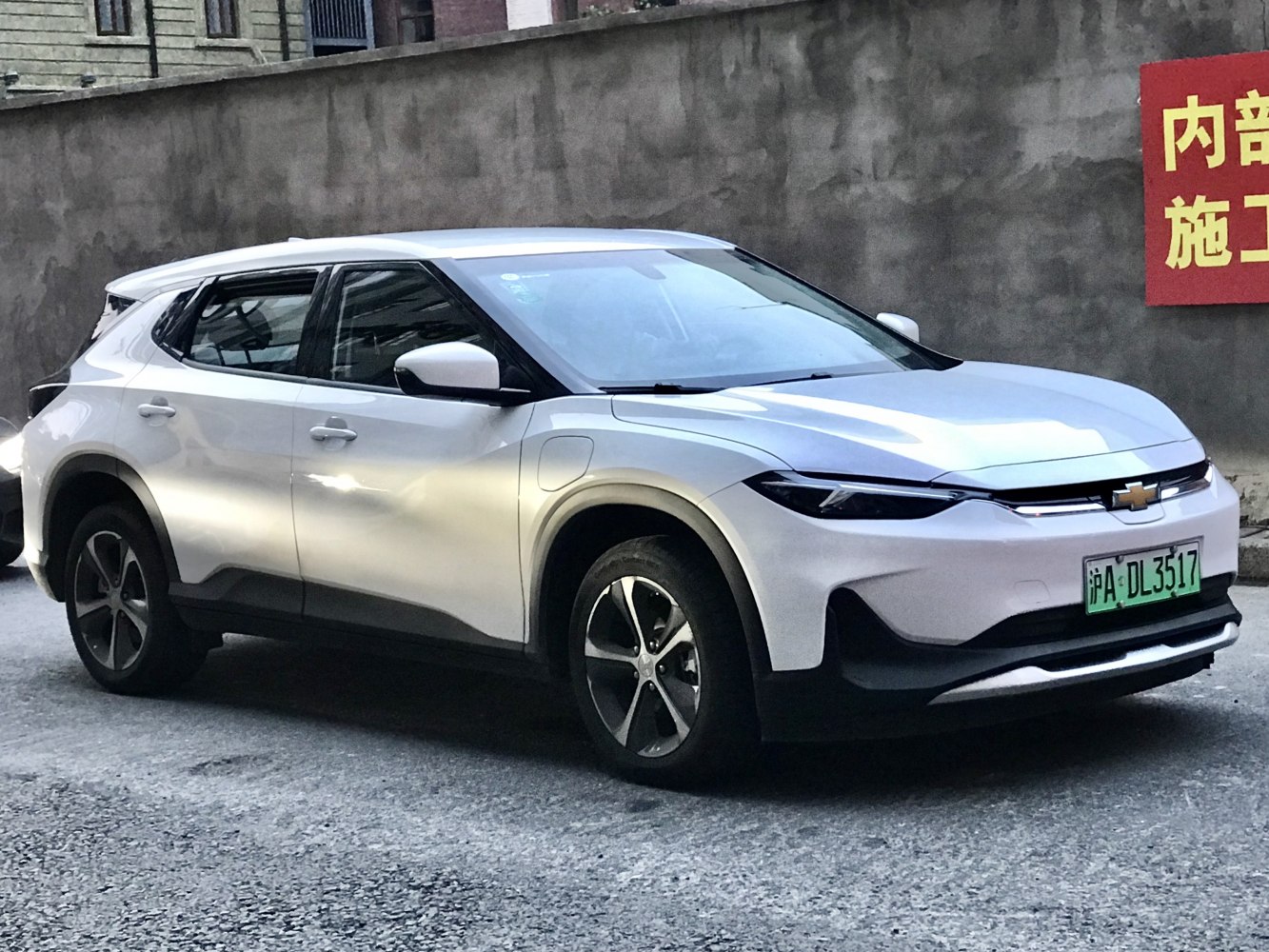 White electric SUV front side view with sleek headlights and aerodynamic shape