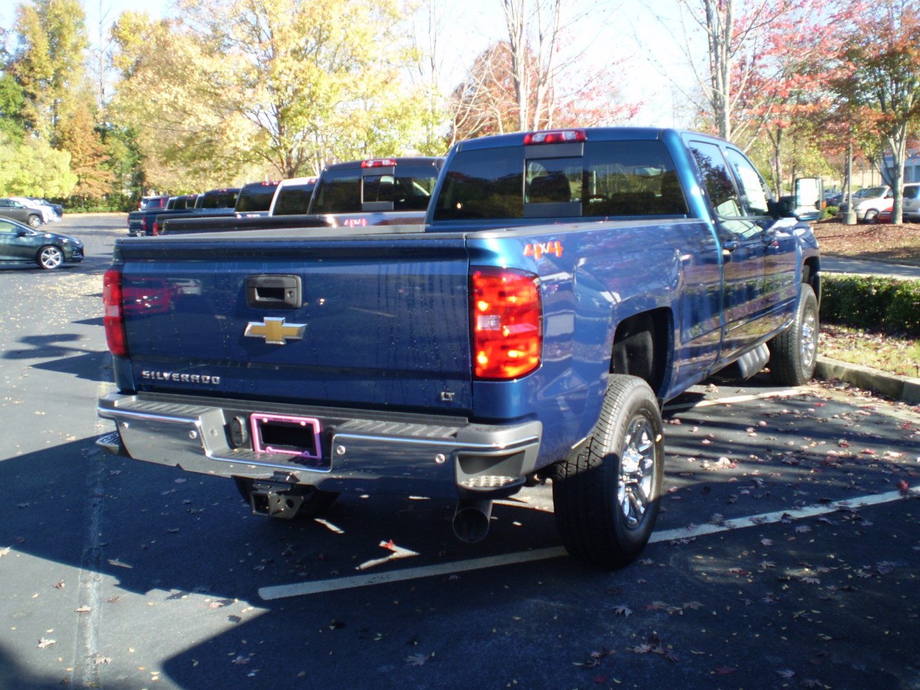 Rear view of heavy-duty 4x4 crew cab pickup with long bed and tailgate.