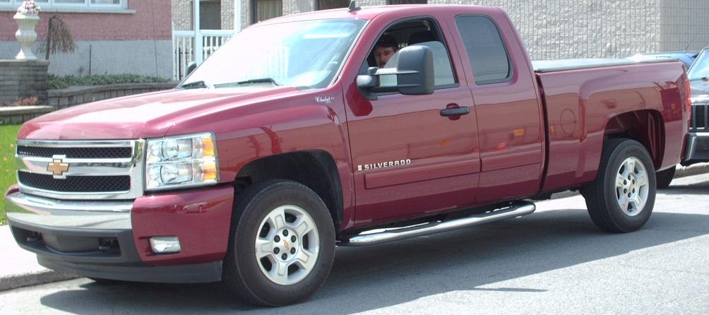 Red extended cab long box pickup truck side profile with chrome accents.