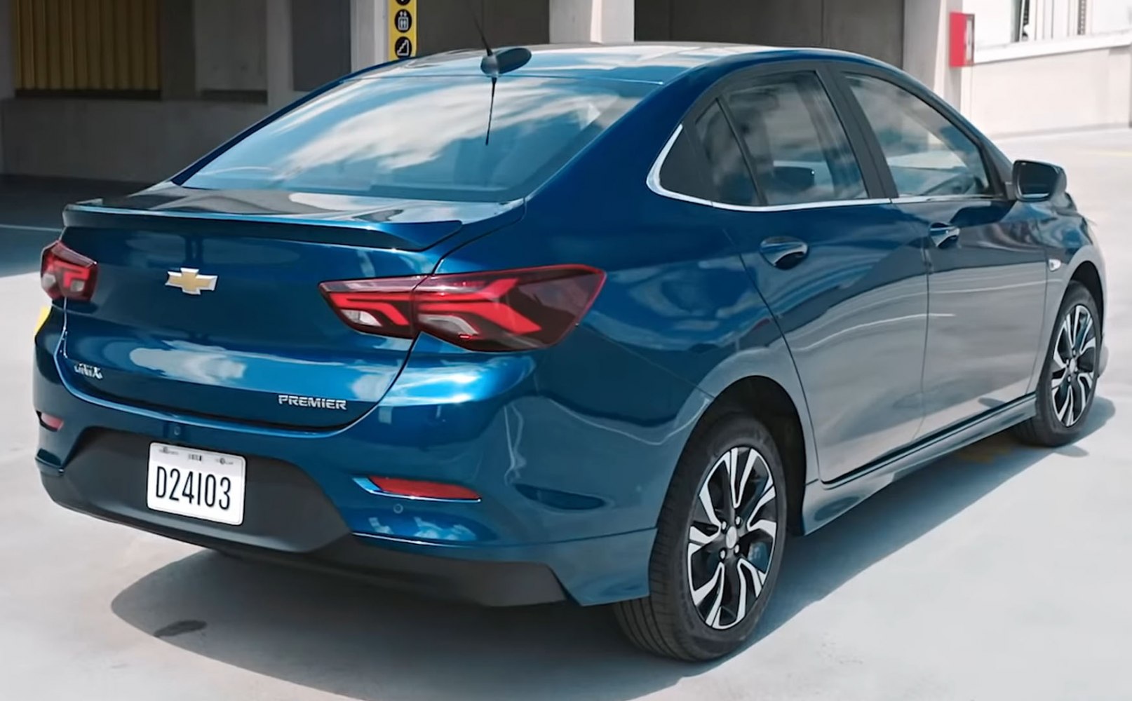 Rear view with distinctive tail lights and trunk spoiler