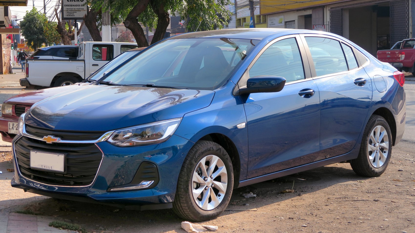 Front grille and LED headlights of a blue sedan