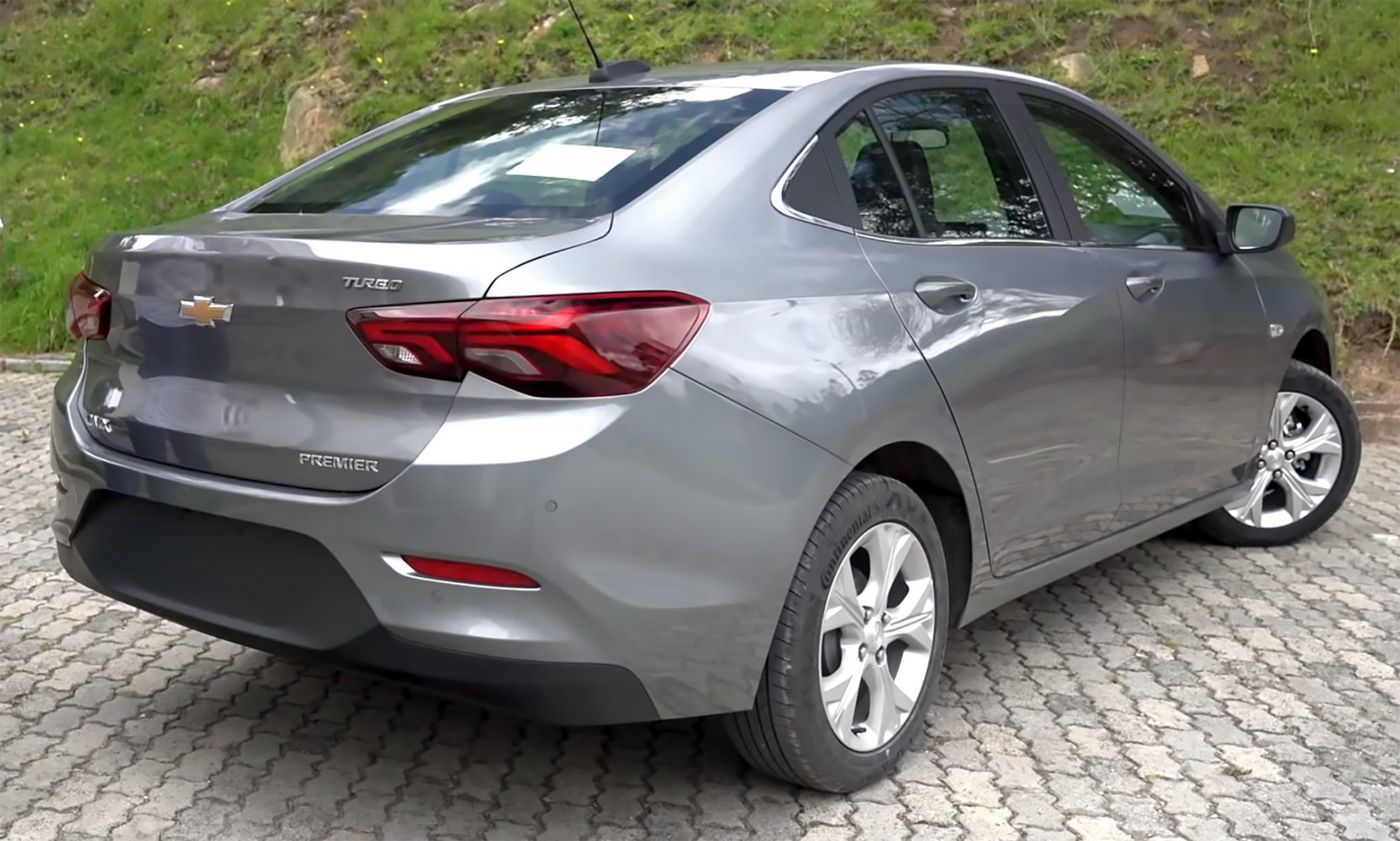 Silver Chevrolet sedan rear-side with turbo badge and alloy wheels