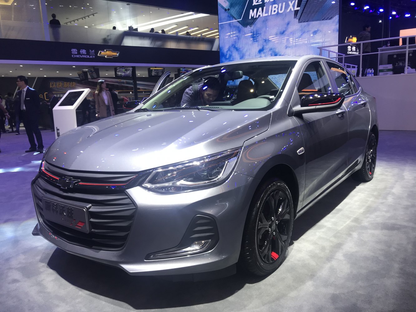 Silver compact sedan with LED headlights, black grille and sporty black wheels with red accents