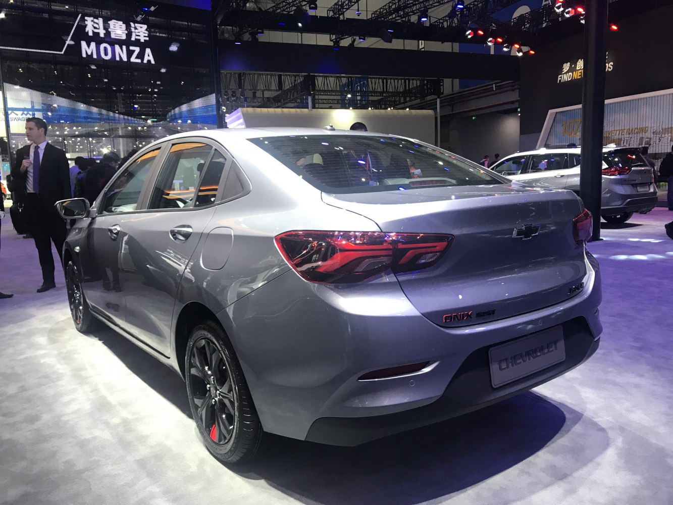 Rear view of modern sedan with sharp tail lights and alloy wheels