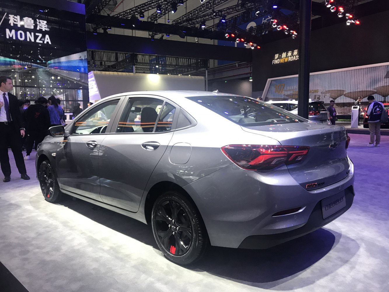 Rear view of a modern sedan with black alloy wheels and distinctive tail lights.