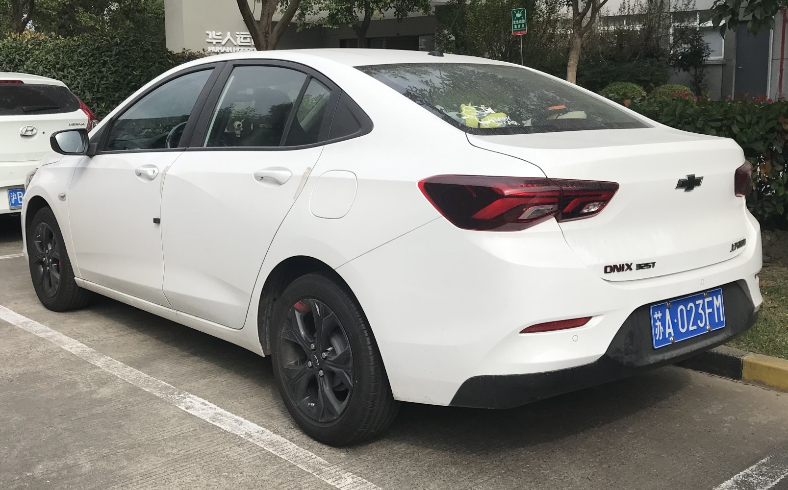 White sedan with tinted tail lights and black rims