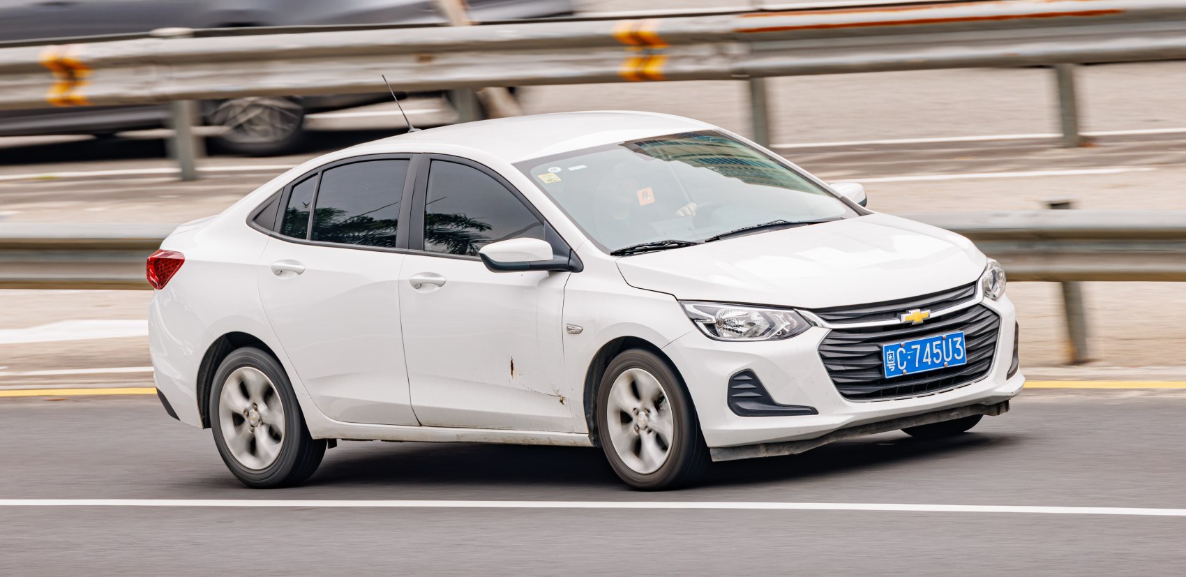 White sedan with sleek headlights and modern grille design.