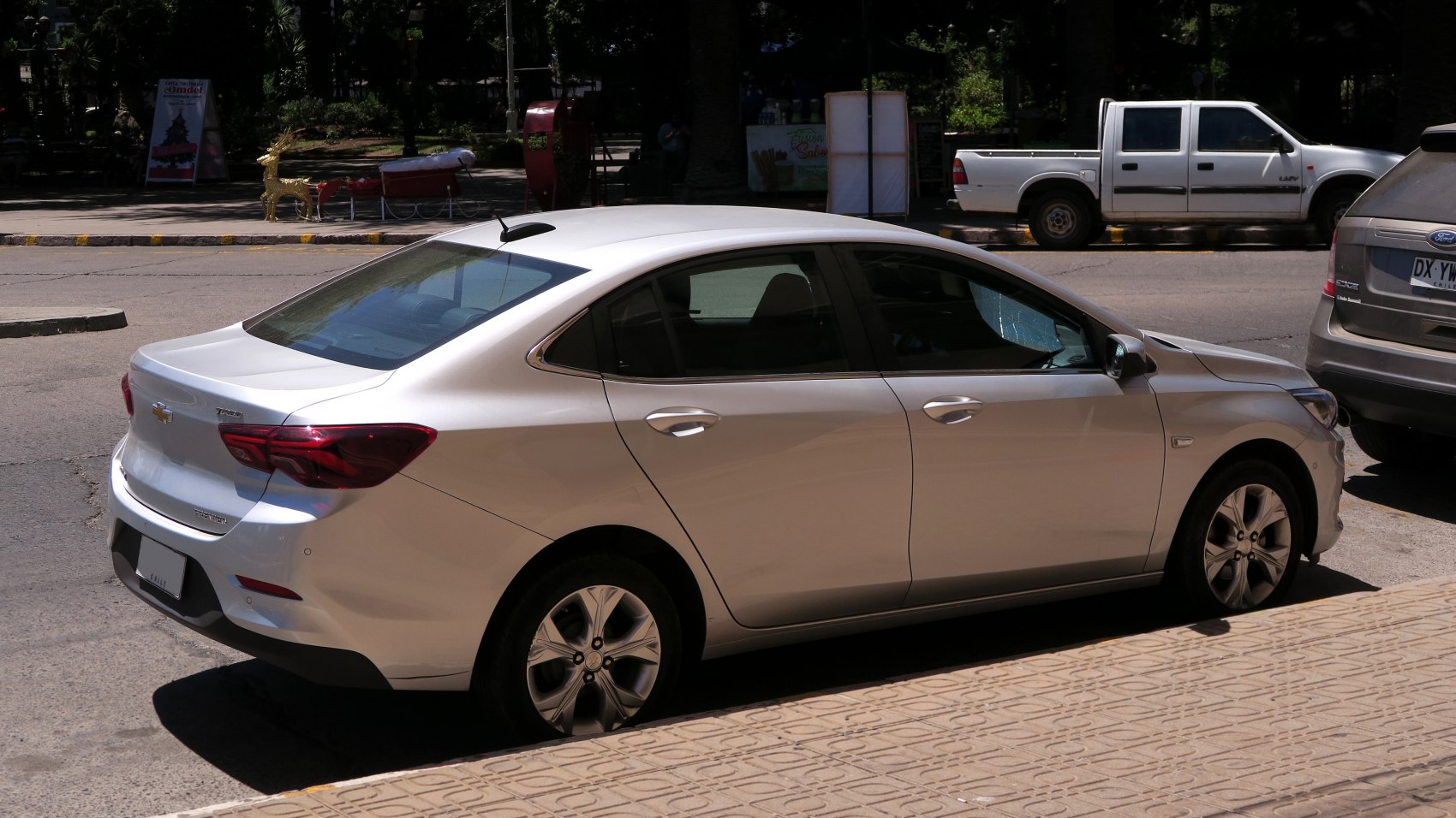 Rear side view of a modern sedan with distinctive tail lights and alloy wheels