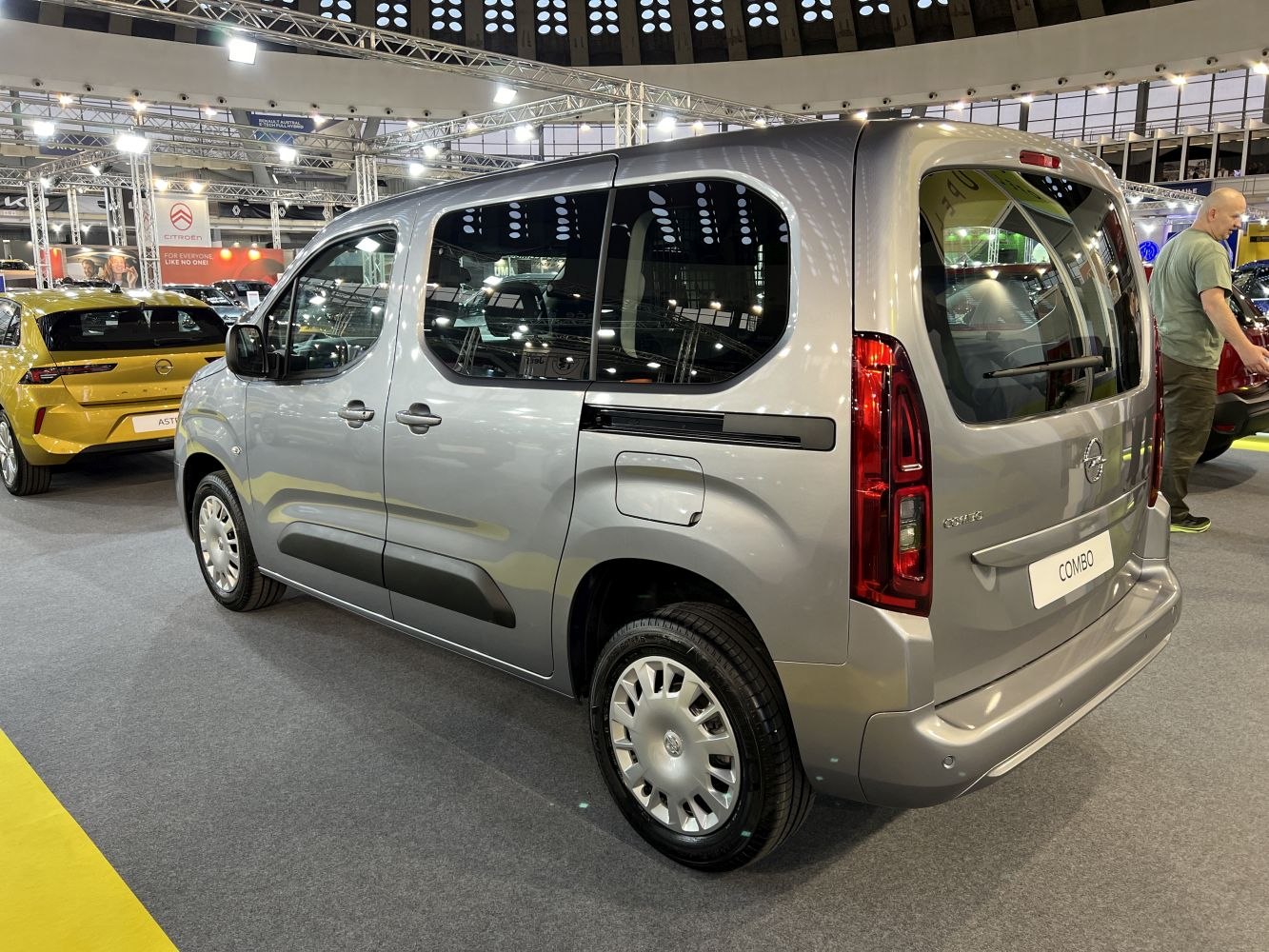 Rear-side view of a minivan with distinctive rear windows and vertical tail lights