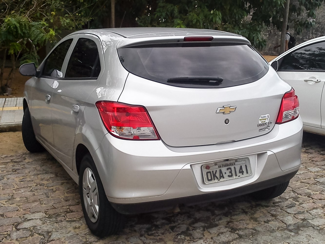 Rear hatchback view with taillights, tinted window, and silver body