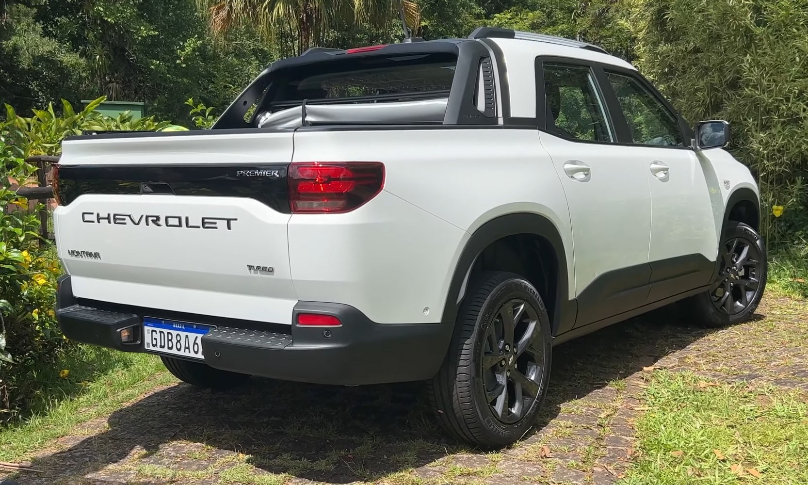 Rear side view with pickup bed, turbo badge, and black alloy wheels