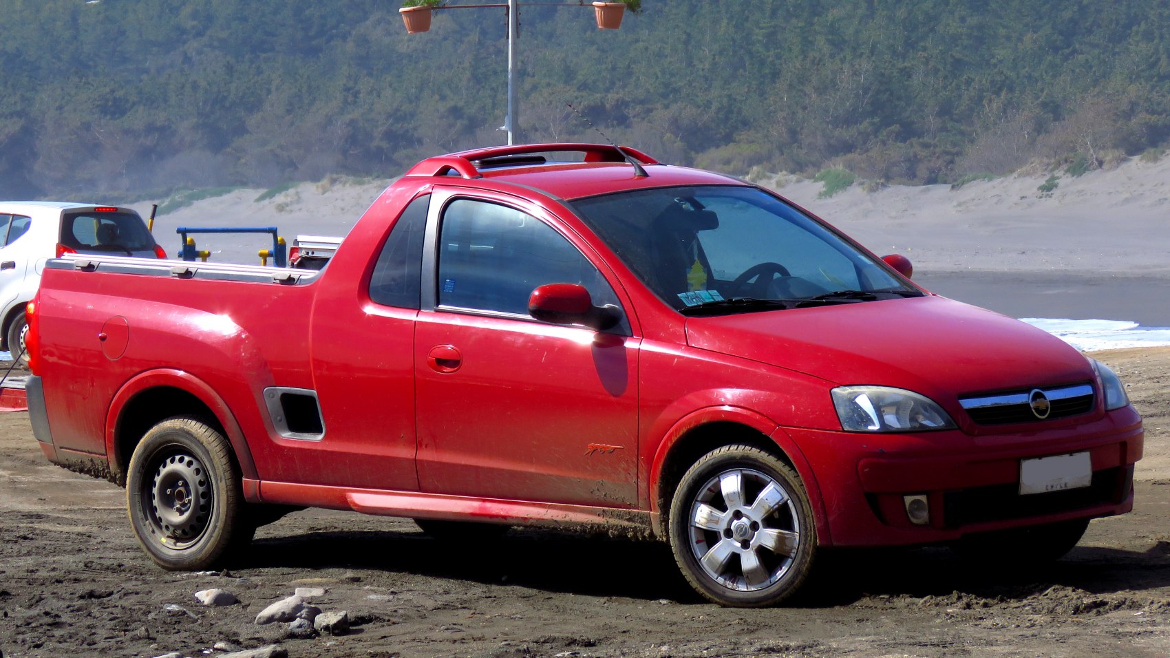 Red pickup truck with sporty roof rails and dual wheel design