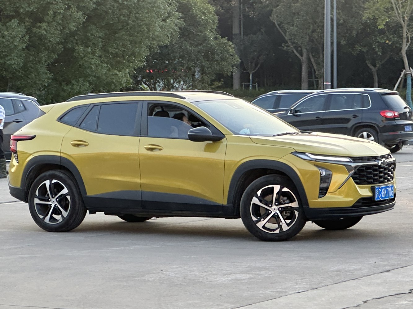 Modern split headlights and sleek SUV side profile in yellow.
